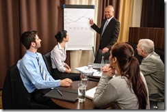 Business man at team meeting point flip-chart