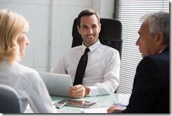 Three businesspeople having a meeting in the office with a laptop computer and a digital tablet